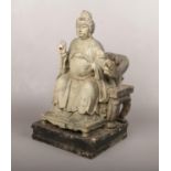 A 19th century Chinese carved wood figure of a seated official, 39cm. Some losses and damage.