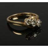 A 18ct gold 3 stone diamond cross over ring, approximately 0.75 carat diamond, size M, gross