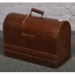 A Singer sewing machine in dome top case.
