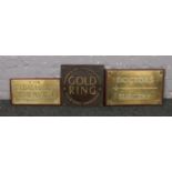 A Gold Ring Jewellers metal sign, along with two brass on oak signs; Doctor's Surgery and