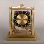 A Schatz four glass brass and perspex anniversary clock. With black chapter ring and Westminster, St