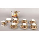 A collection of Noritake coffee set, landscape scene cups, saucers, coffee pot, sugar bowl. Chips to