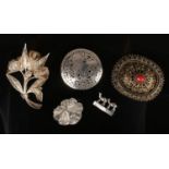 Five silver brooches (acid tested) including a Burmese pierced roundel brooch, Stanetzky camel