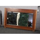 A large bevelled mirror in oak frame, 148cm x 95cm. Formerly part of a mirrorback sideboard,