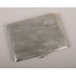 A George V silver cigarette case, of rectangular form with thumb mould opening, partially engine