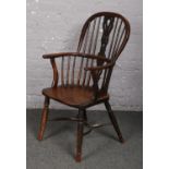 A 19th century ash and elm Windsor armchair with crinoline stretcher. One spindle bound together.