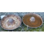 Two cast iron Mexican hat shaped troughs.