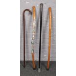 Four walking sticks, to include ebonised example with white metal pommel.