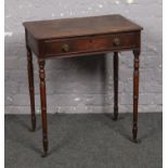 A Regency mahogany single drawer side table. With brass drawer pulls and raised on ring turned