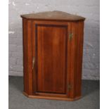 A George III oak corner cupboard, 90cm high.