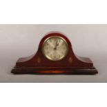 A small mahogany dome top mantel clock. With silvered dial and transfer pateras.