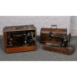 Two Singer sewing machines in original wooden cases.