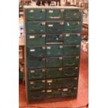 A vintage painted steel engineers workshop cabinet with a bank of 24 drawers, 138cm high.