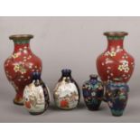 A pair of red ground Japanese cloisonne vases, a smaller pair and a pair of Satsuma vases. Largest