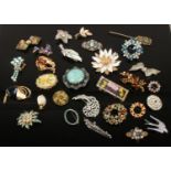 A collection of vintage costume jewellery brooches including coloured and white paste examples.