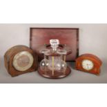 A box of miscellaneous, to include two mantle clocks, a wooden serving tray and a wooden decanter