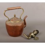 A Victorian copper kettle and a brass barrel tap.