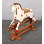 A vintage white painted wooden rocking horse by Leeway.