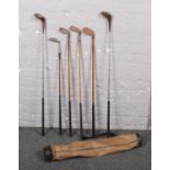 A golf bag and selection of vintage golf clubs, to include hickory shaft examples, Aitken, Gibson