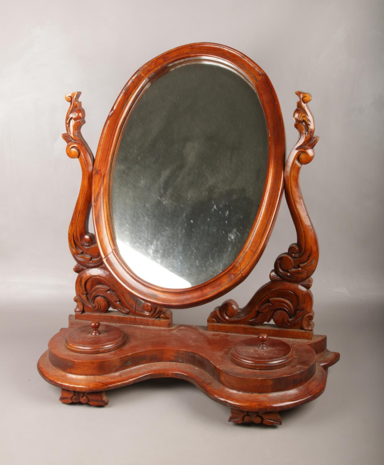 A Victorian carved mahogany toilet mirror. (Height 72cm).