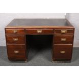 A mid 20th century mahogany desk with inset top.