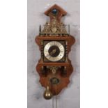 A United Clockworks, made in Holland wall clock, mahogany case with brass figural decoration,