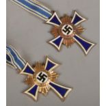 Two WWII German third reich mothers cross medals on chain, dated to the reverse.