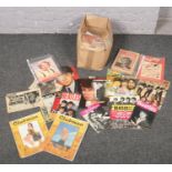 A box of ephemera to include Beatles magazines, telegraphs, cigarette cards etc.