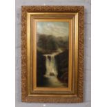An early 20th century gilt frame oil on canvas, landscape scene with a waterfall. (50cm x 25cm).
