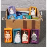A box of Deagostini porcelain collectable dolls, Elizabeth, Sally, Miss Julie examples.