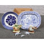 A box of miscellaneous ceramics, large plates, elephant figurines.