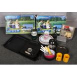 Two boxed Campingaz camping chef stoves along with a quantity of picnic plate, cutlery etc.