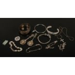 A collection of silver, mainly jewellery. Including bangles, pierced decorative spoons, bracelets