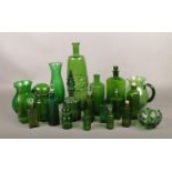 A collection of green glass, to include vases, jugs, bottles etc.