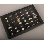 A display box of 36 dress rings to include white paste stone examples etc.