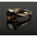 A 9ct gold smokey quartz dress ring. (3.38g).