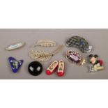 A box of costume jewellery brooches including Butler & Wilson owl and ruby slippers etc.