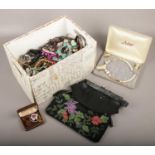 A box of costume jewellery to include bangles, beads, necklaces, beaded bag etc.