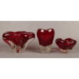 A Whitefriars glass ruby red molar vase with controlled bubble pattern by Geoffrey Baxter along with