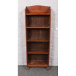 A mahogany open bookcase with fixed shelves, 120cm x 40cm. Some damage to front foot, top back panel