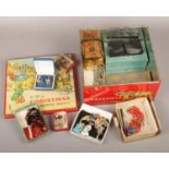 A vintage Christmas biscuit tin containing assorted boxed costume jewellery and oddments.