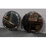 Two circular bevelled edged mirrors.