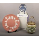 A Wedgwood Jasperware; a boxed Portland vase, a terracotta plate and an olive green biscuit