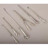 A collection of silver handled items to include button hooks, glove stretchers, letter opener etc.