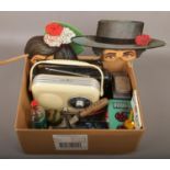 A box of miscellaneous including two radios, tinplate toy cooking range, vuntage tins and novelty