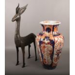 A decorative metal figure of a gazelle, along with a 19th century Imari vase. Vase repaired.