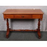 A Victorian mahogany washstand with single drawer, raised on turned supports.