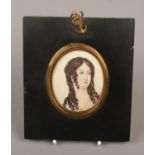 A Regency watercolour portrait miniature of a girl in ebonized frame, 6.5cm x 5.5cm.