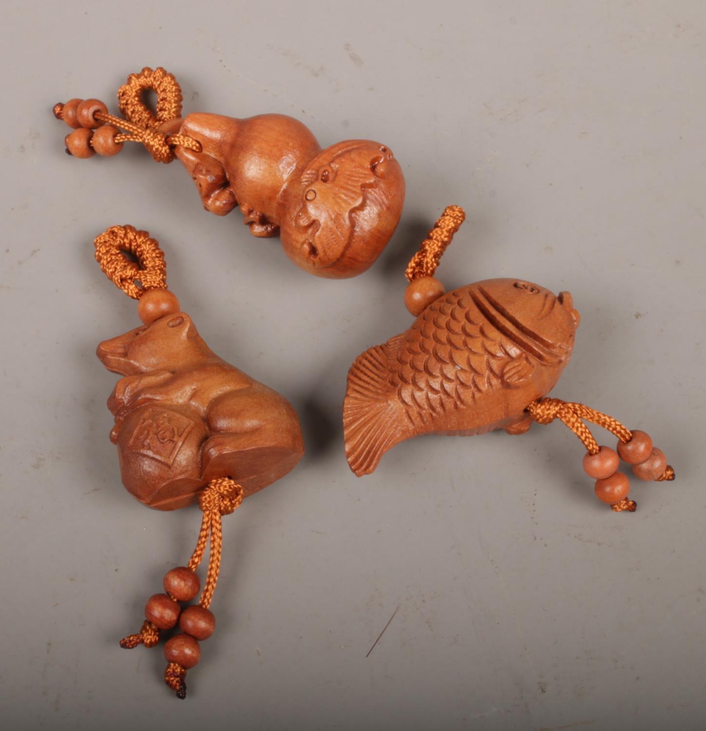 Three carved netsukes, to include mouse, fish and dragon.
