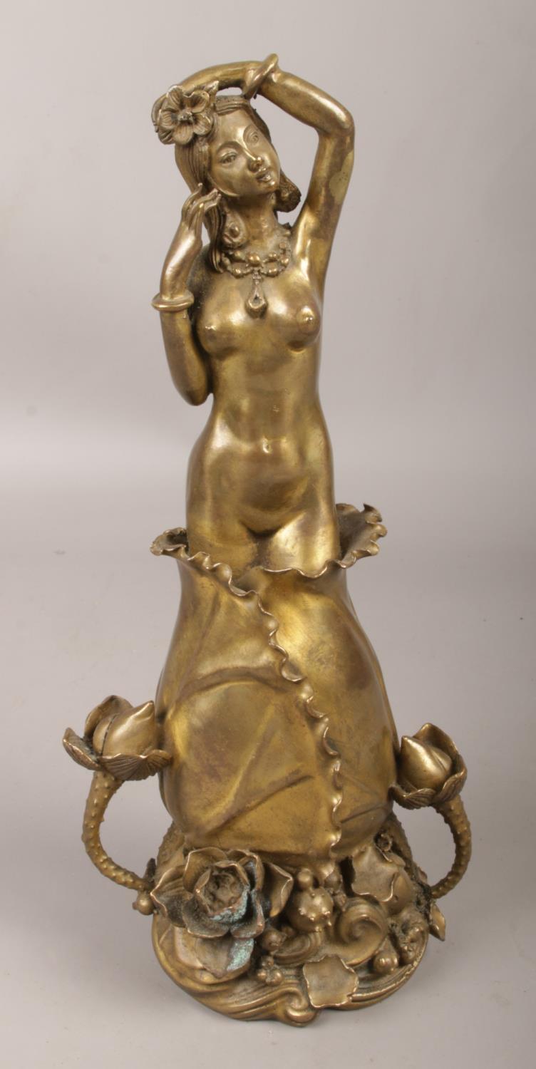 An Art Nouveau style bronze figure of a nude maiden. (Height 27cm).